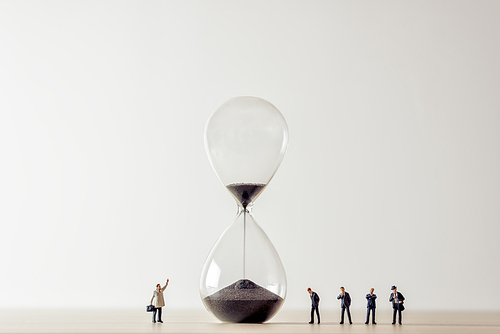Conceptual image of business people looking at Hourglass.