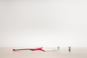 Little kid and mom looking at a giant toothbrush