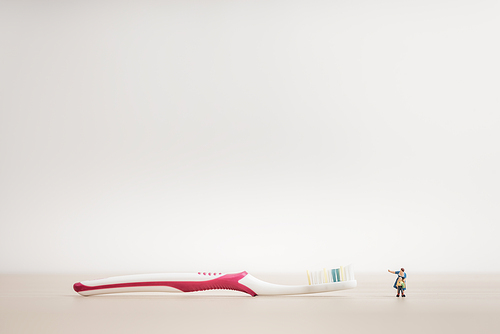 Little kid and mom looking at a giant toothbrush
