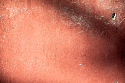 Washed-out red concrete wall background