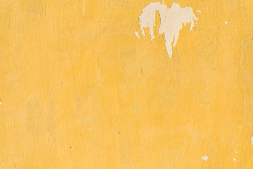 Old yellow painted weathered wall
