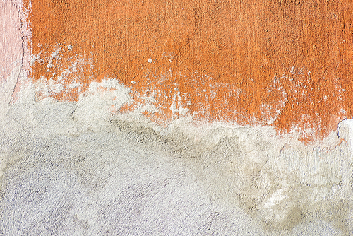 Old orange painted weathered wall