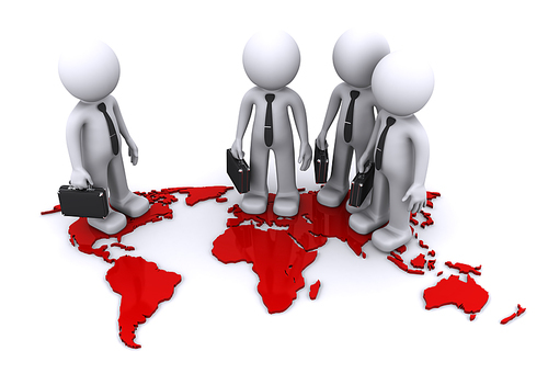 Group of businesmen standding on world map