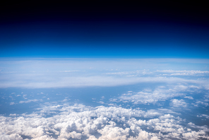 Fluffy white clouds and blue sky. Stratosphere. View from above.