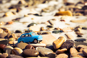 Vintage Toy Car on the beach. Travel and adventure concept.