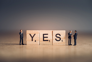 Wooden tiles with letters spelling out the word Yes. Business concept.