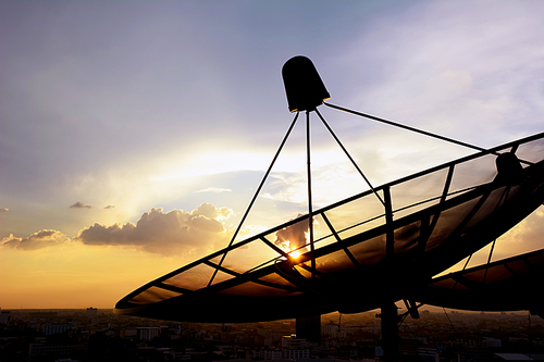 Satellite dishes on twilight sky background