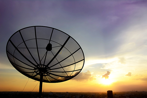 Satellite dish on twlight sky background