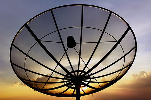 Satellite dish on twlight sky background