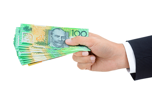 Hand of businessman giving money, Australian dollar (AUD) banknotes, on white background