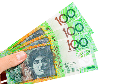 Hand holding money, Australian dollar (AUD) banknotes, isolated on white