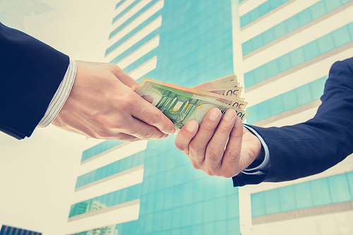 Businessman hands passing money, Euro currency (EUR) - vintage tone