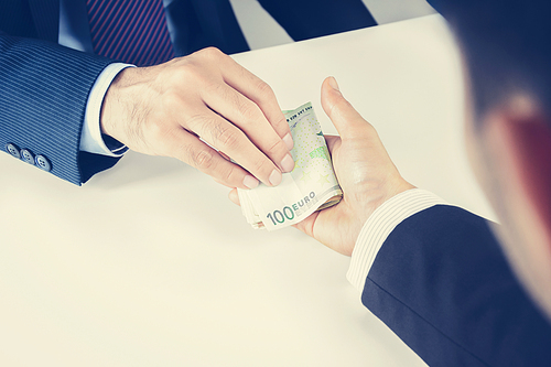 Businessman hands passing money, Euro currency (EUR), bribery concept - vintage tone