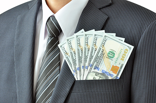 Money - United States dollar (USD) bills - in businessman suit pocket