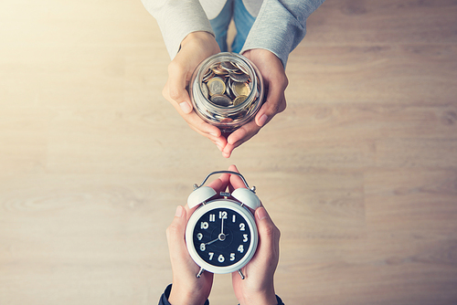 Hands holding money exchanging with time, business and financial metaphor