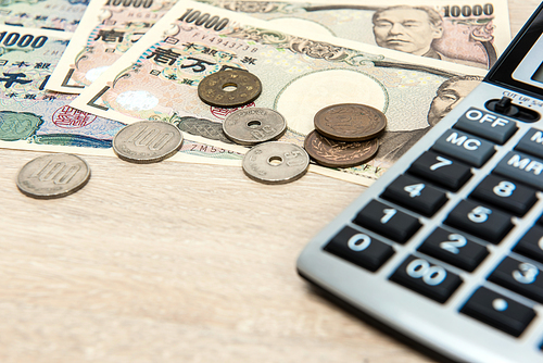 Money, Japanese Yen (JPY), with calculator on the table