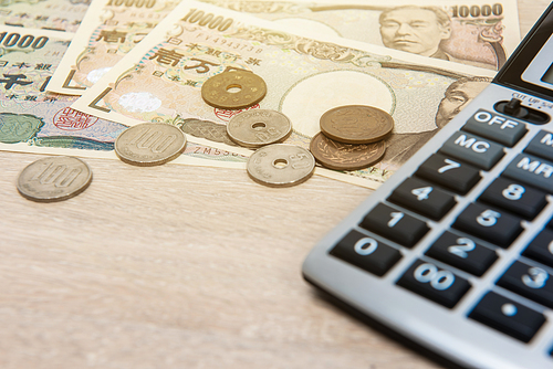 Money, Japanese Yen (JPY), with calculator on the table