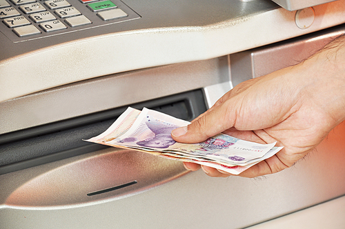 Man taking money from ATM