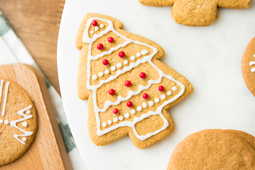 Homemade Christmas tree shape gingerbread cookie decorated with icing on top