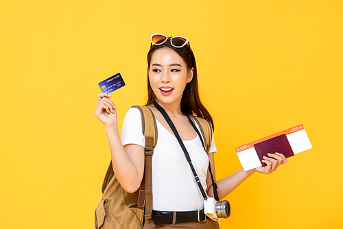 Smiling Asian woman tourist showing credit card for payment on vacation traveling