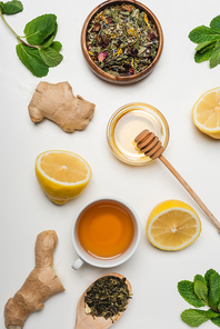 Top view of honey, cup of tea and mint on white background