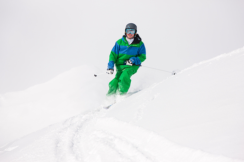 Man on a ski track going downhill, very beautiful alpine mountains