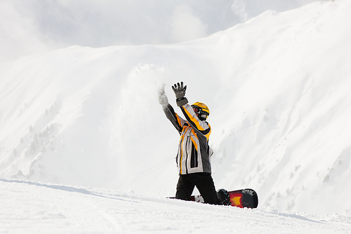 Snowboarder in the snow in winter, probably he is waiting for somebody