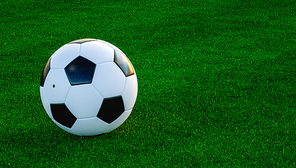 Ball placed on bright green grass of football field during match on summer day. Copy space