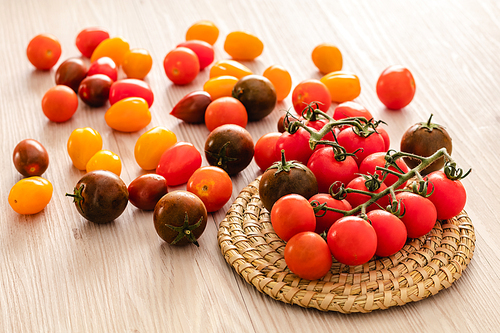 Small red cherry tomatoes on rustic background