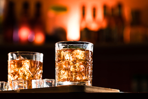 Whiskey glasses with ice in a lounge bar