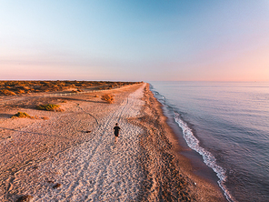 One running men on sunset. Aerial View