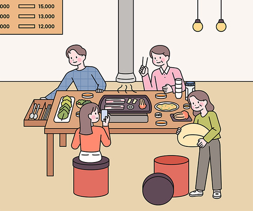 삼겹살 식당에서 식사를 하는 가족들. 한국의 톡특한 문화를 보여준다.