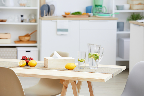 Close-up of fresh lemonade and fruits are on the wooden table in modern kitchen in the house