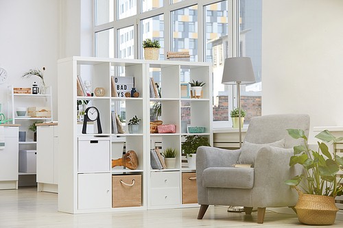 Image of modern domestic room with armchair and bookcase in the house