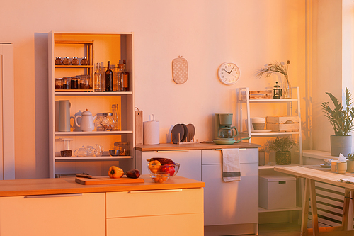 Image of empty domestic kitchen with kitchen table and modern furniture