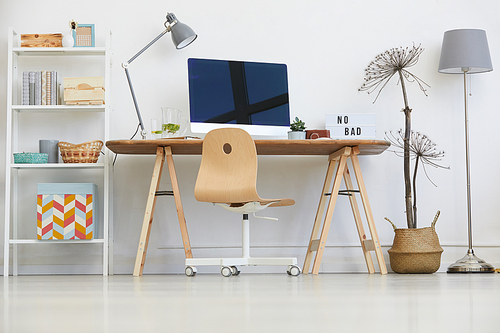 Image of table with computer monitor on it in domestic room at home