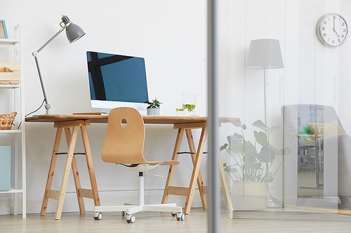 Image of table with computer monitor in the living room for online work