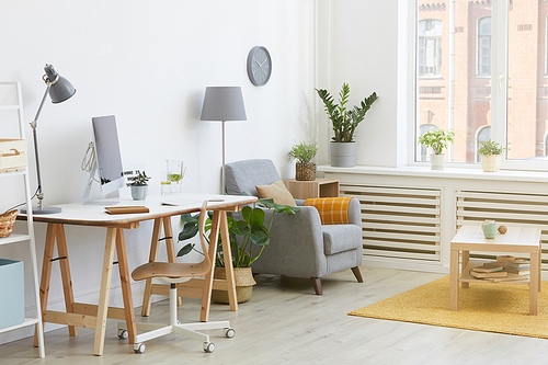 Image of domestic room with workplace with computer and armchair at the house