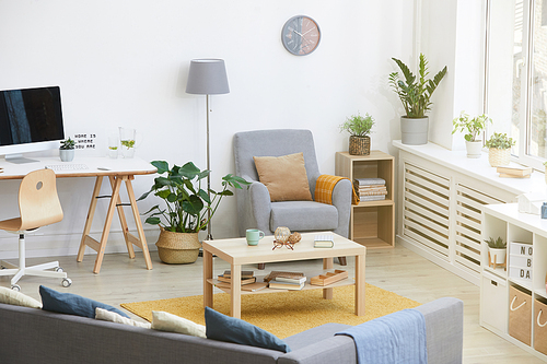 Image of domestic room with modern furniture and table with computer at home