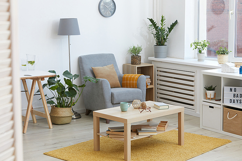 Image of modern domestic room with armchair and table in the house