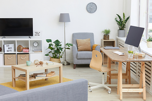 Image of modern living room with TV and table with computer in the house