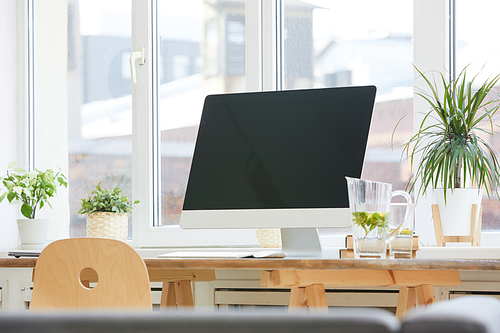 Image of big computer monitor on the wooden table at office