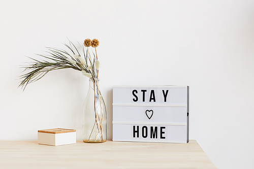 Image of table with flowers and poster on it at home