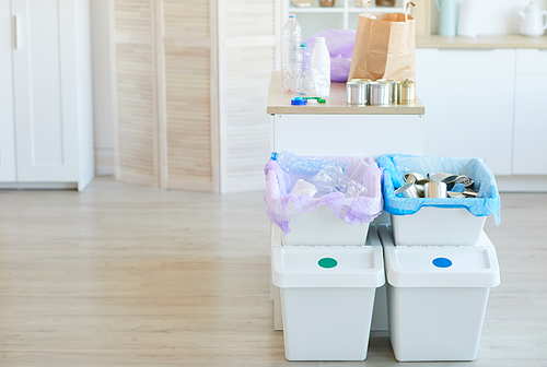 Group of bins with different sorted garbage in the domestic room