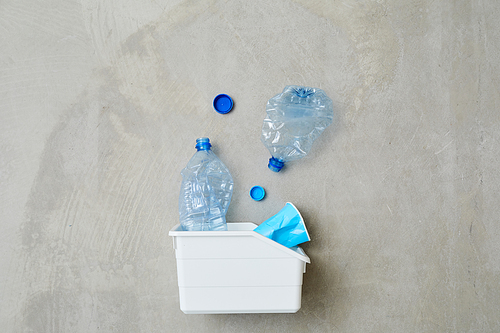 Close-up of plastic container with waste isolated on grey background