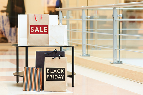 Image of abundance paper bags are on the shopping mall after big sale