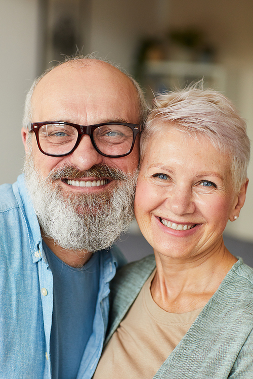Portrait of senior happy family smiling at camera and embracing