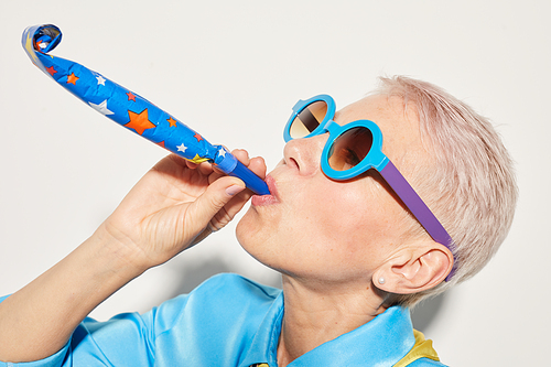Close-up of mature woman in sunglasses having fun at party isolated on white background