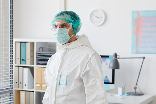 Male doctor wearing protective clothing standing at the hospital