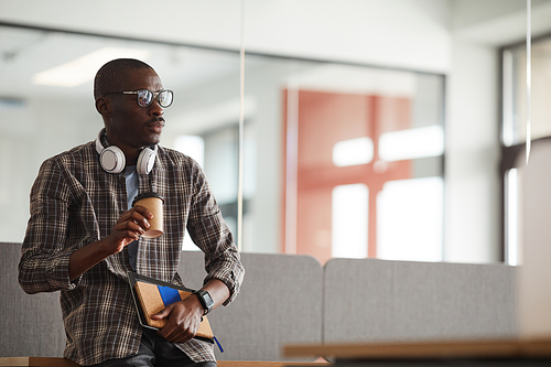 African young businessman in casual clothing drinking coffee he has a coffee break